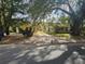 House exterior with a long driveway and trees at 1040 Maxey Dr, Winter Garden, FL 34787