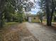 Yellow house exterior with a long driveway at 1040 Maxey Dr, Winter Garden, FL 34787