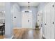 Bright entryway with light gray walls, wood-look floors, and white doors at 10446 Summit Lakes Ln, Clermont, FL 34711