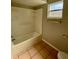 Bathroom features a shower/tub combo and tile flooring at 115 Cardamon Dr, Orlando, FL 32825