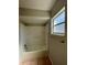 Updated bathroom with shower/tub combo and tile flooring at 115 Cardamon Dr, Orlando, FL 32825