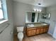 Bathroom with double vanity and a large mirror at 115 Cardamon Dr, Orlando, FL 32825