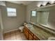 Clean bathroom with single vanity and a large mirror at 115 Cardamon Dr, Orlando, FL 32825