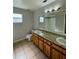 Clean bathroom with double vanity and a large mirror at 115 Cardamon Dr, Orlando, FL 32825