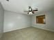 Bedroom with ceiling fan, window, and tile flooring at 115 Cardamon Dr, Orlando, FL 32825