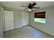 Simple bedroom with ceiling fan and large closet at 115 Cardamon Dr, Orlando, FL 32825