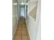 Clean hallway with tile flooring and neutral walls at 115 Cardamon Dr, Orlando, FL 32825