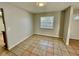 Living room with tile floor, neutral walls, and a window at 115 Cardamon Dr, Orlando, FL 32825