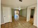 Living room with tile floors and view to sunroom at 115 Cardamon Dr, Orlando, FL 32825