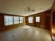 Sunroom with tile floor, wood paneling and ceiling fan at 115 Cardamon Dr, Orlando, FL 32825