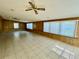 Sunroom with tile floor, wood paneling and window at 115 Cardamon Dr, Orlando, FL 32825