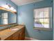 Bathroom with granite countertop, single sink, and window at 115 N Lake Florence Dr, Winter Haven, FL 33884