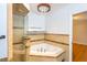 Bathroom featuring a corner bathtub, glass shower enclosure, and chandelier at 115 N Lake Florence Dr, Winter Haven, FL 33884