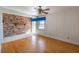 Bedroom with hardwood floors, brick accent wall, and water views at 115 N Lake Florence Dr, Winter Haven, FL 33884