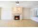 Spacious living room with stone fireplace and hardwood floors at 115 N Lake Florence Dr, Winter Haven, FL 33884