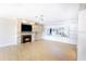 Living room with fireplace, built-in shelving, and hardwood floors at 115 N Lake Florence Dr, Winter Haven, FL 33884