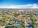 Aerial view showing a neighborhood with trees, homes with pools, and a distant city skyline against a blue sky at 1250 Chichester St, Orlando, FL 32803