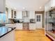 Bright kitchen featuring white cabinets, stainless steel appliances, and hardwood floors at 1250 Chichester St, Orlando, FL 32803