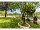Landscaped backyard with pond views and lush greenery at 12666 Moss Park Ridge Dr, Orlando, FL 32832