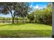 Large backyard with pond and lush landscaping at 12666 Moss Park Ridge Dr, Orlando, FL 32832