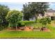 Landscaped backyard with raised garden beds and fruit trees at 12666 Moss Park Ridge Dr, Orlando, FL 32832