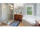 Bathroom with soaking tub, walk-in shower, and single vanity at 12666 Moss Park Ridge Dr, Orlando, FL 32832