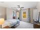 Charming bedroom with window and ceiling fan at 12666 Moss Park Ridge Dr, Orlando, FL 32832