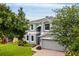 Two story home with gray siding and brick driveway at 12666 Moss Park Ridge Dr, Orlando, FL 32832