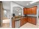 Open kitchen with granite counters, stainless steel appliances, and wood cabinets at 12666 Moss Park Ridge Dr, Orlando, FL 32832