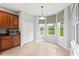 Kitchen nook with bay windows overlooking a tranquil pond at 12666 Moss Park Ridge Dr, Orlando, FL 32832