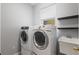 Laundry room with washer, dryer, and shelving at 12666 Moss Park Ridge Dr, Orlando, FL 32832