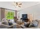 Relaxing living room with sectional sofa and a large TV at 12666 Moss Park Ridge Dr, Orlando, FL 32832