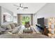 Spacious living room featuring a large sectional sofa and sliding glass doors at 12666 Moss Park Ridge Dr, Orlando, FL 32832