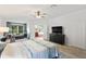Main bedroom with ensuite bathroom and a large TV at 12666 Moss Park Ridge Dr, Orlando, FL 32832