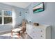 Bedroom with comfy armchair, dresser, and large window offering natural light at 136 Madiera Beach Blvd, Kissimmee, FL 34746