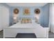 Bright bedroom with white platform bed, accent pillows, and wall art at 136 Madiera Beach Blvd, Kissimmee, FL 34746