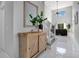 Bright entryway with a wooden cabinet and large mirror at 136 Madiera Beach Blvd, Kissimmee, FL 34746