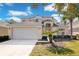 Two-story house with attached garage and landscaping at 136 Madiera Beach Blvd, Kissimmee, FL 34746