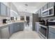 Modern kitchen with stainless steel appliances and gray cabinets at 136 Madiera Beach Blvd, Kissimmee, FL 34746