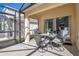 Enclosed patio with table and chairs, perfect for outdoor dining at 136 Madiera Beach Blvd, Kissimmee, FL 34746