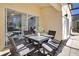 Cozy patio with seating for four, adjacent to the house at 136 Madiera Beach Blvd, Kissimmee, FL 34746