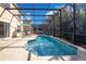 Inviting pool area with screened enclosure, lounge chairs, and a spacious deck at 136 Madiera Beach Blvd, Kissimmee, FL 34746