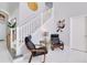 Elegant staircase with white railings and a sitting area below at 136 Madiera Beach Blvd, Kissimmee, FL 34746