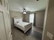 Bedroom with wood-look floors and a white bed frame at 14476 Se 34Th Ct, Summerfield, FL 34491