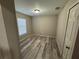 Simple bedroom with wood-look floors and a window at 14476 Se 34Th Ct, Summerfield, FL 34491