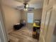 Bedroom with wood-look floors and storage containers at 14476 Se 34Th Ct, Summerfield, FL 34491