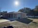 Tan house with a carport and a large yard at 14476 Se 34Th Ct, Summerfield, FL 34491