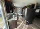 Modern kitchen with dark cabinets, granite countertops, and stainless steel appliances at 14476 Se 34Th Ct, Summerfield, FL 34491