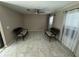 Bright sitting room with tile flooring and two wicker sofas at 14476 Se 34Th Ct, Summerfield, FL 34491