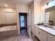 Elegant bathroom with a soaking tub and double vanity at 1584 Sandbagger Dr, Davenport, FL 33896